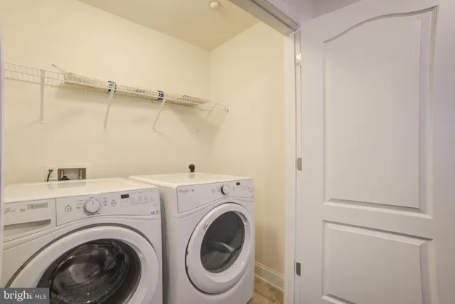 a view of a storage & utility room with dryer and washer