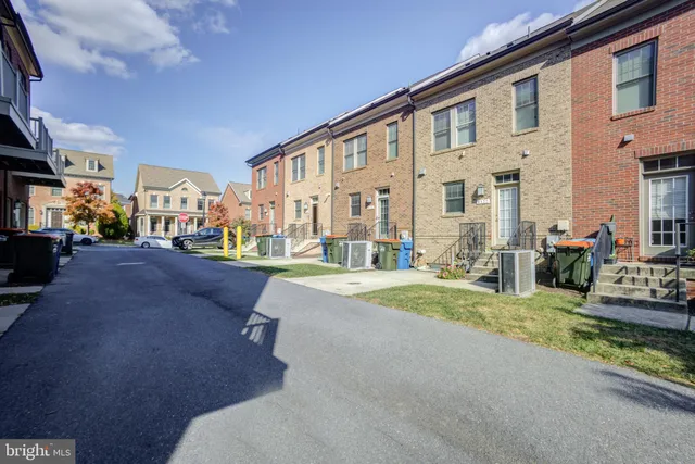a view of a building with cars parked on the road