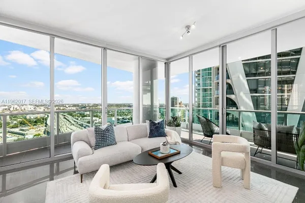 a living room with furniture and a large window