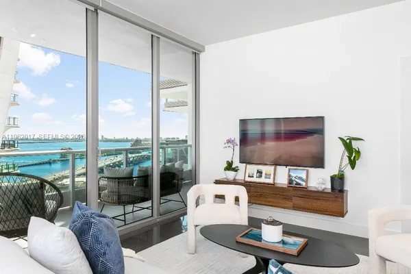 a living room with furniture and a floor to ceiling window