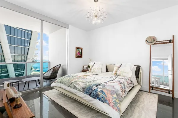 a bedroom with a bed couch and a window