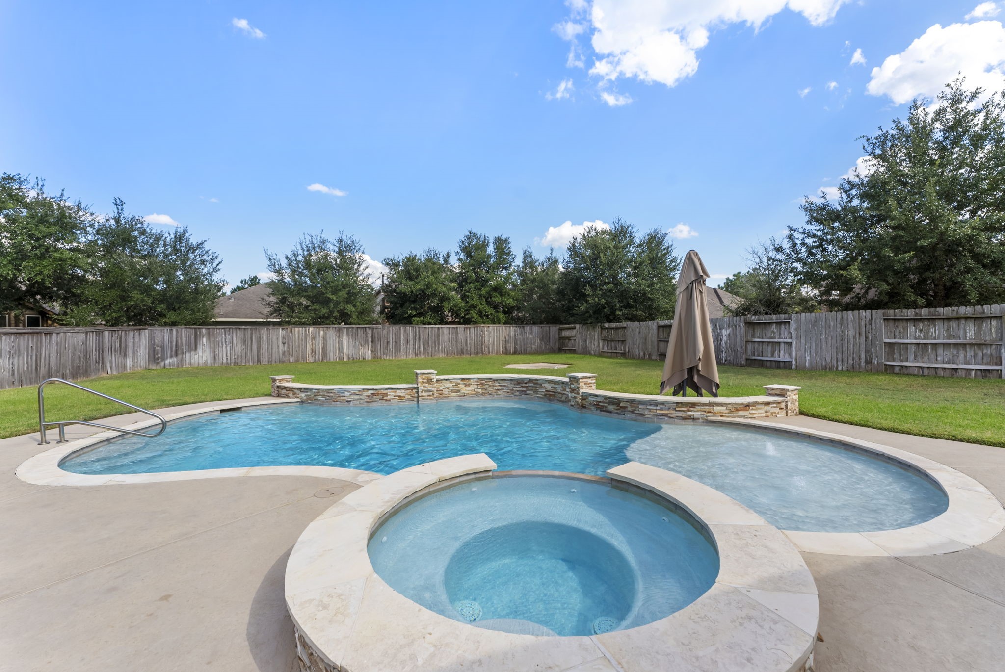 119 Wood Drake Place Tomball, TX 77375 - Photo 1 of 47 a view of a swimming pool with a sitting area