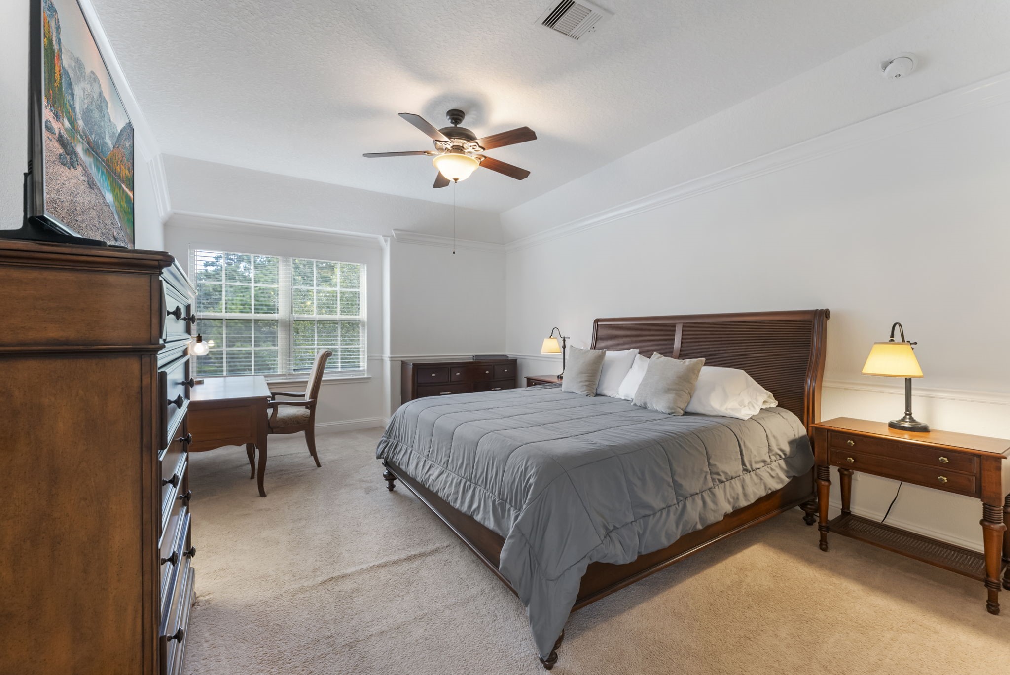 119 Wood Drake Place Tomball, TX 77375 - Photo 24 of 47 a bedroom with a bed and a chandelier