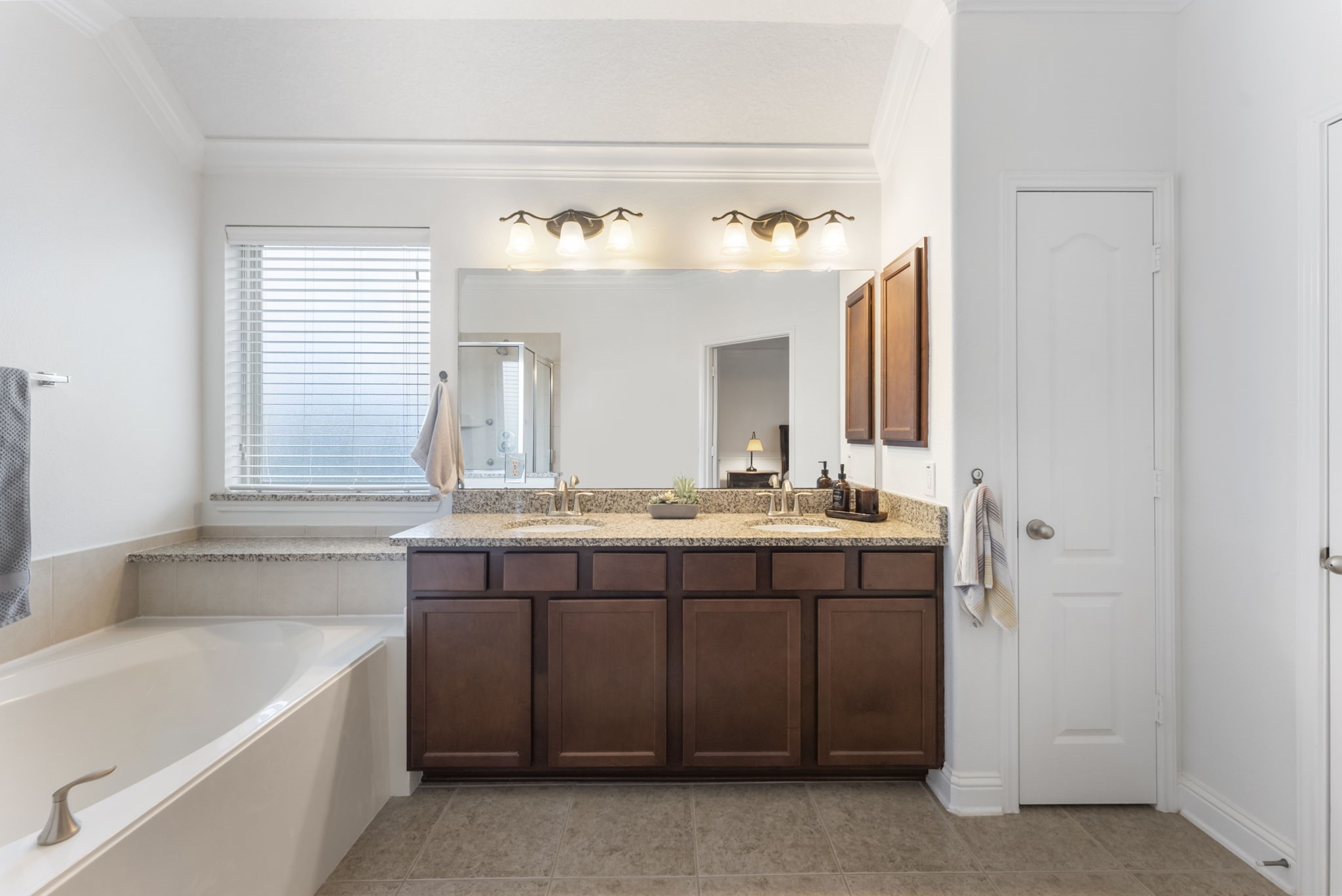 119 Wood Drake Place Tomball, TX 77375 - Photo 26 of 47 a bathroom with a granite countertop sink and a bathtub