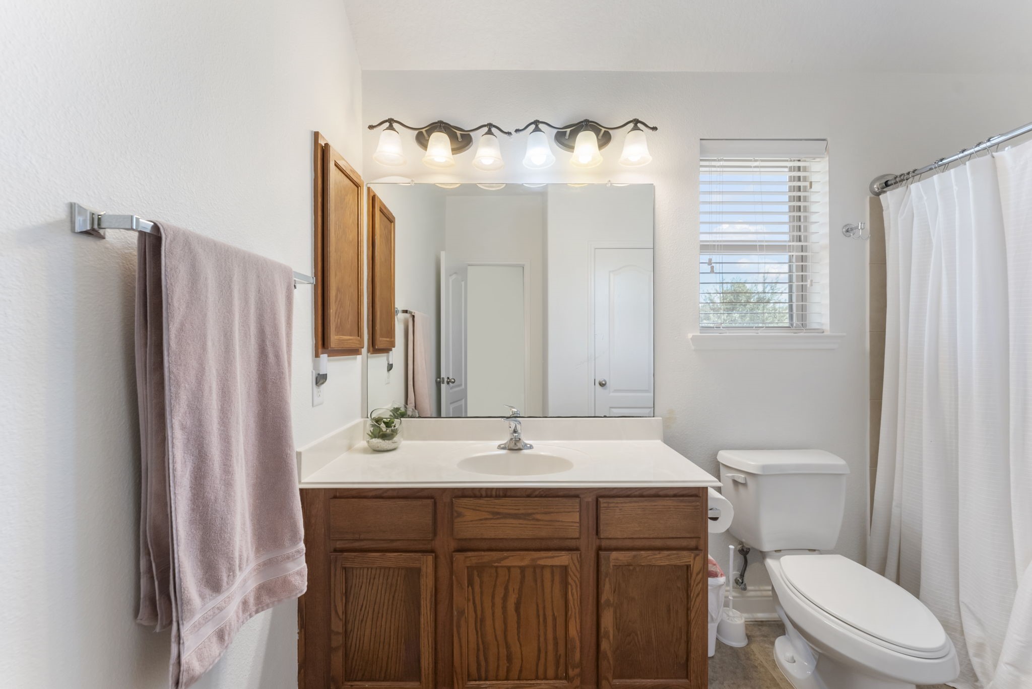 119 Wood Drake Place Tomball, TX 77375 - Photo 31 of 47 a bathroom with a sink vanity mirror and toilet
