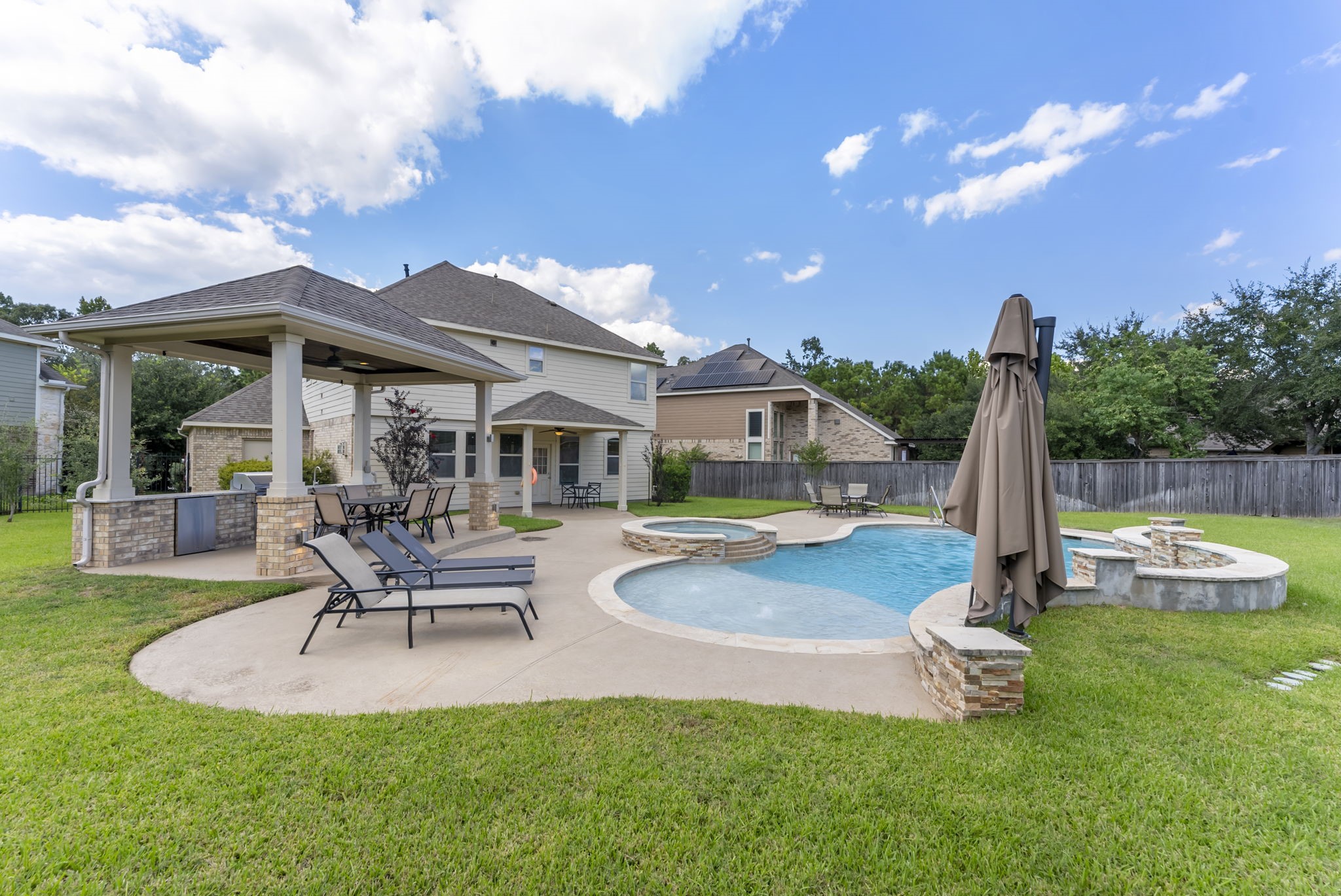 119 Wood Drake Place Tomball, TX 77375 - Photo 40 of 47 a front view of a house with swimming pool and porch with furniture