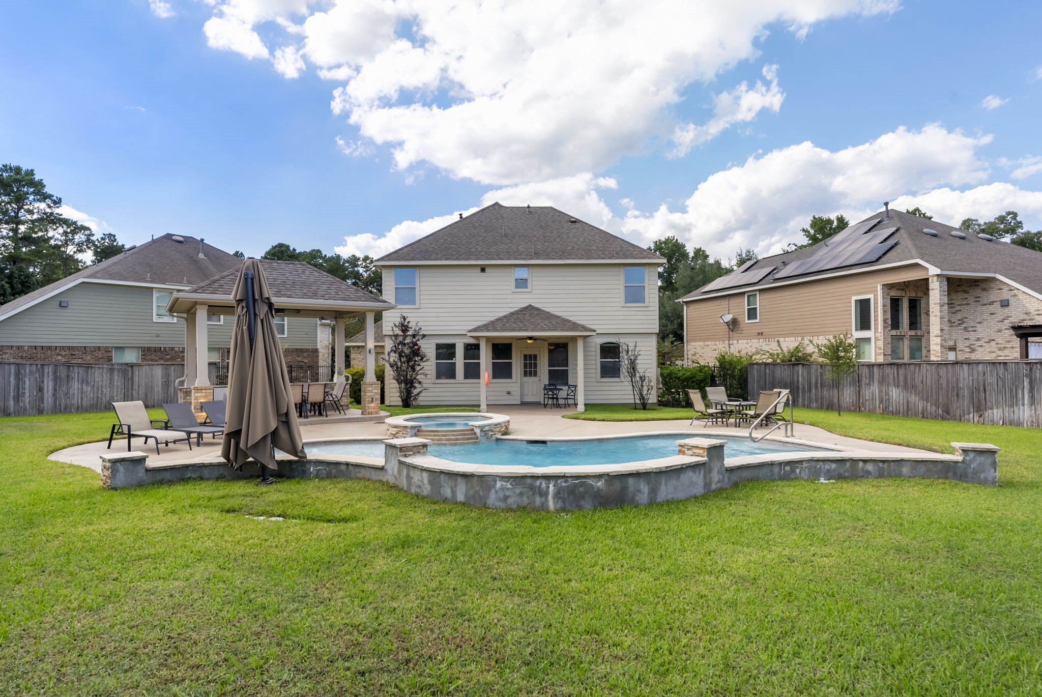 119 Wood Drake Place Tomball, TX 77375 - Photo 47 of 47 a view of a house with a swimming pool and porch