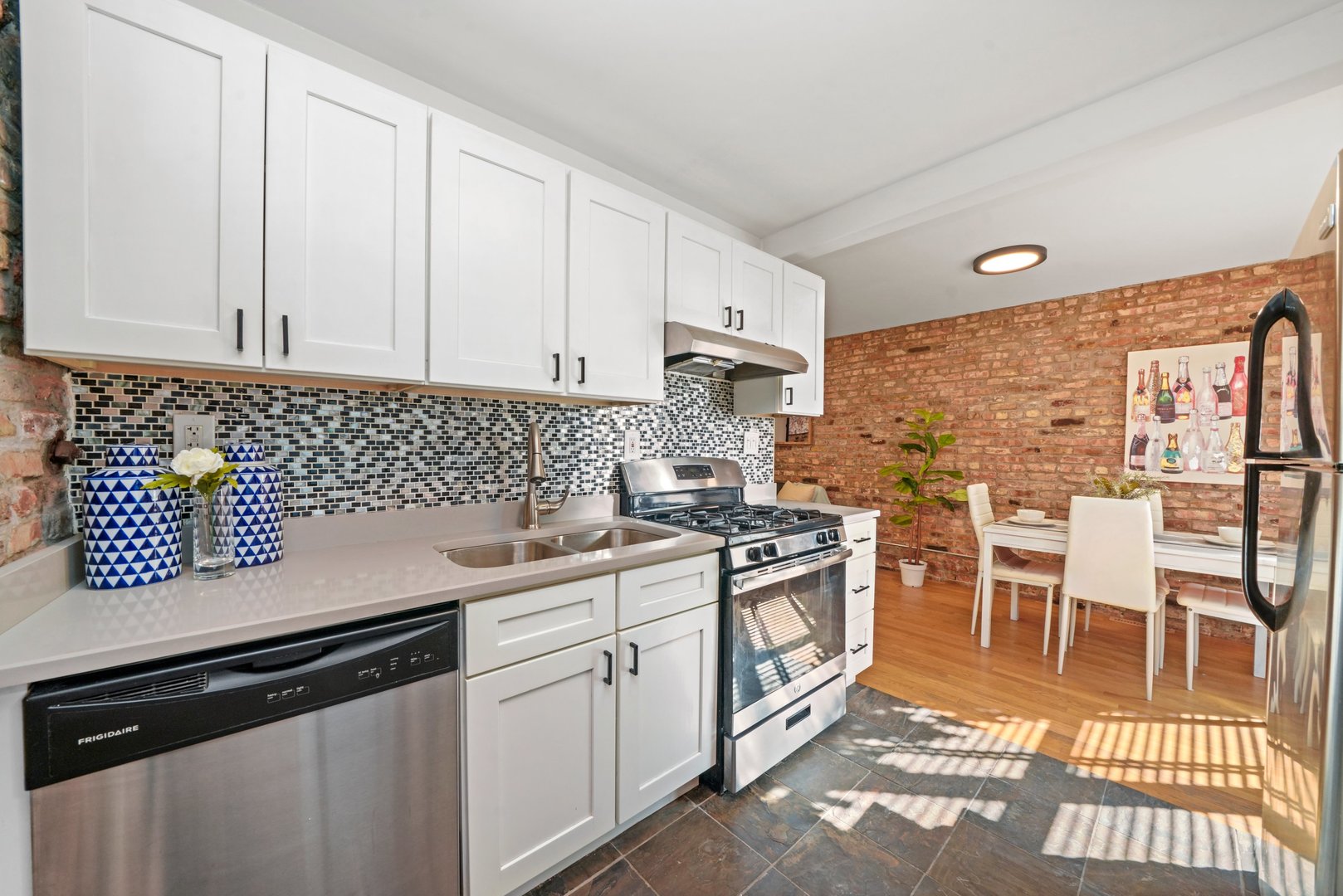 464 North Aberdeen Street, Unit 1R Chicago, IL 60642 - Photo 3 of 16 a kitchen with a sink stove and cabinets