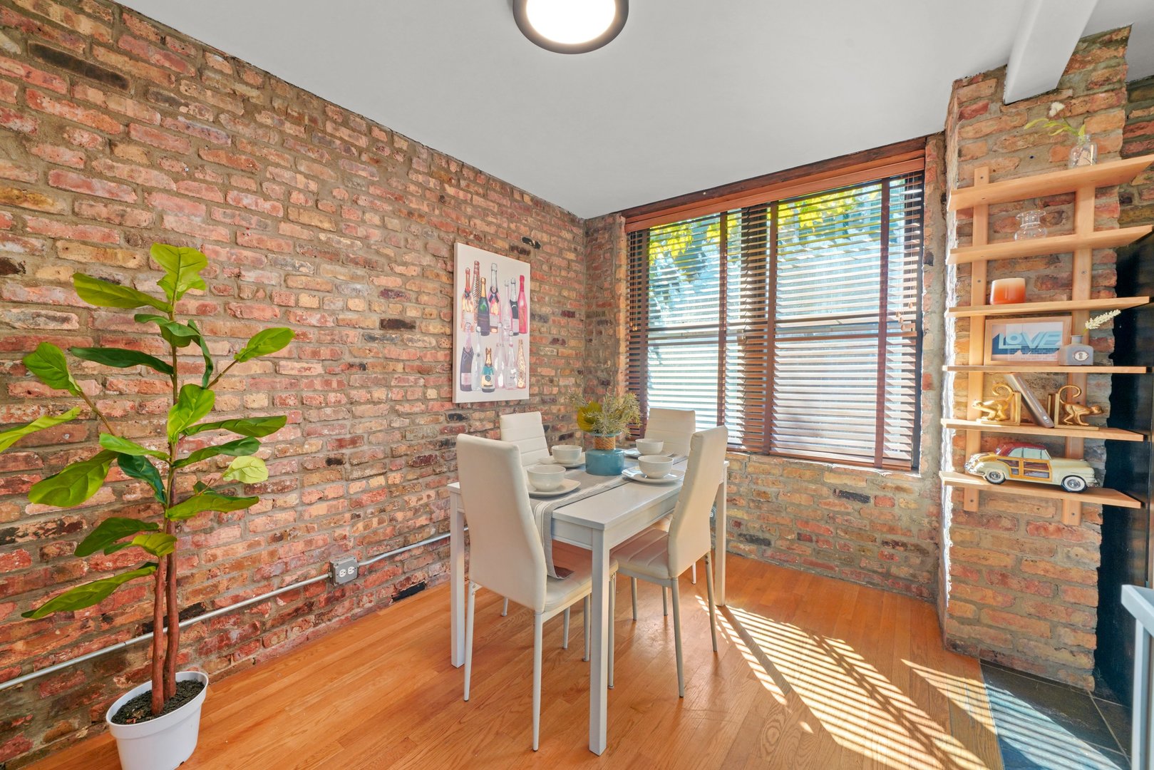 464 North Aberdeen Street, Unit 1R Chicago, IL 60642 - Photo 4 of 16 a dining room with furniture and wooden floor