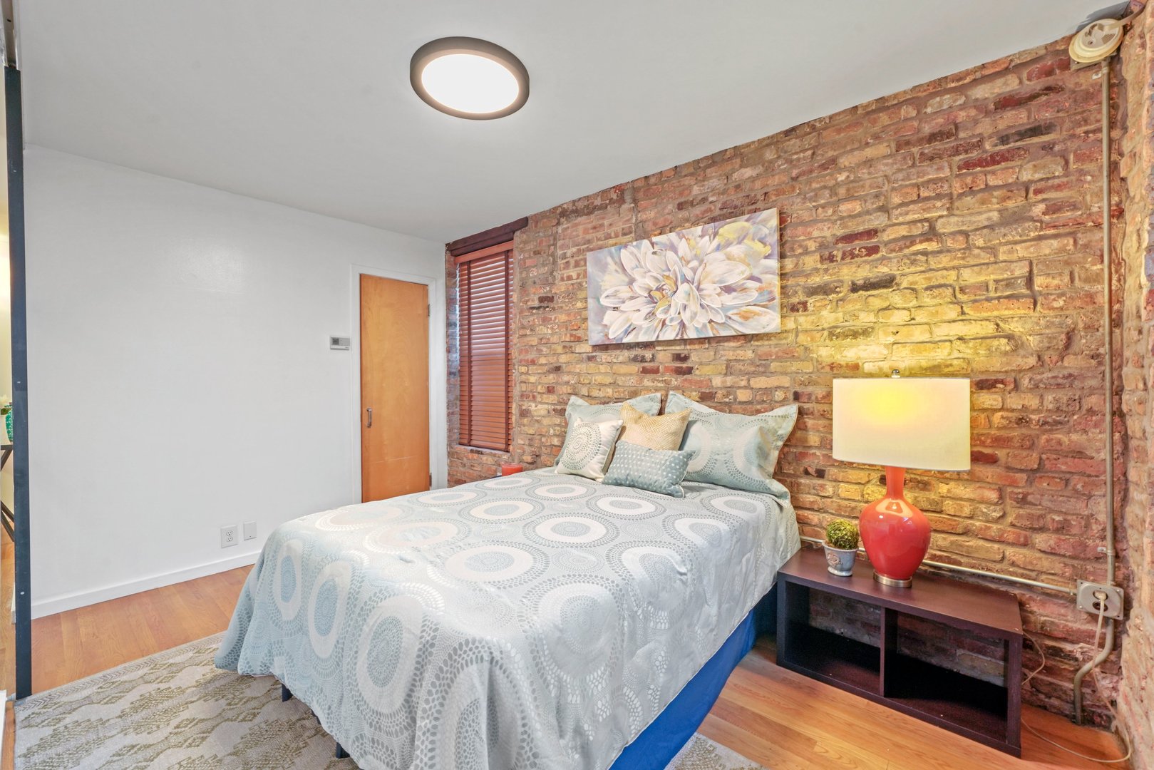 464 North Aberdeen Street, Unit 1R Chicago, IL 60642 - Photo 10 of 16 a bedroom with a bed and a window