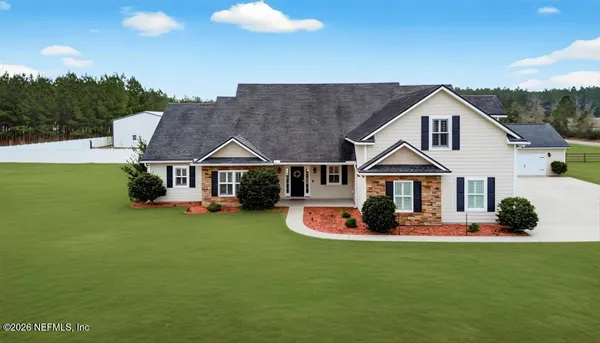 a front view of a house with a garden and porch