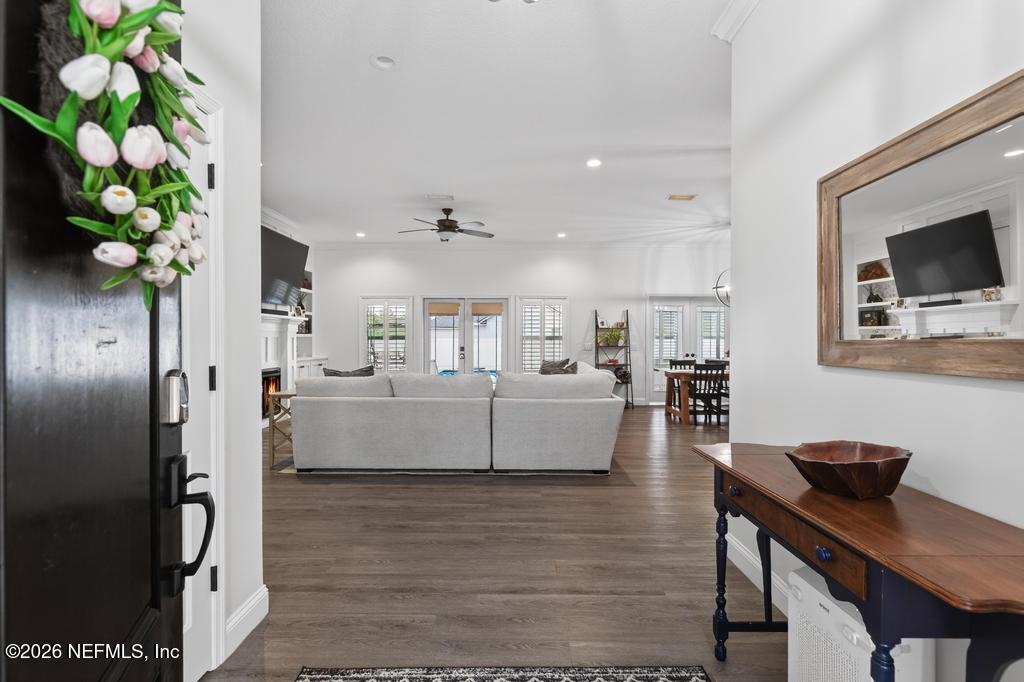 37575 Kings Ferry Road Hilliard, FL 32046 - Photo 15 of 83 a living room with furniture a potted plant and kitchen view