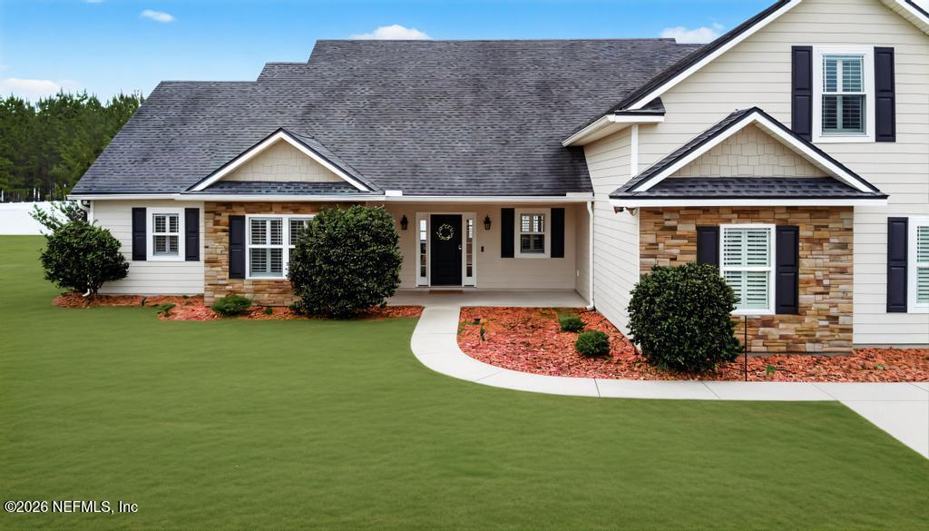 37575 Kings Ferry Road Hilliard, FL 32046 - Photo 2 of 83 a front view of a house with a yard