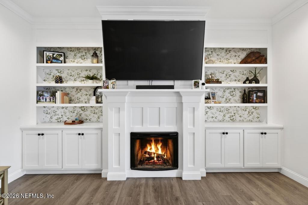 37575 Kings Ferry Road Hilliard, FL 32046 - Photo 21 of 83 a living room with stainless steel appliances furniture a fireplace and wooden floor