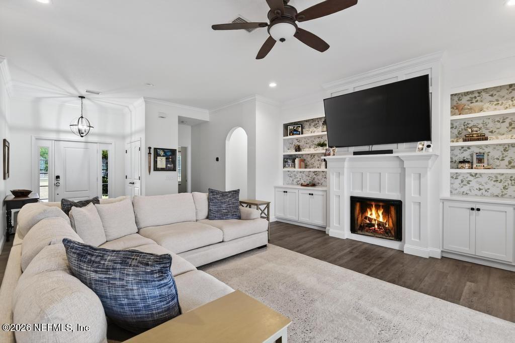 37575 Kings Ferry Road Hilliard, FL 32046 - Photo 22 of 83 a living room with furniture a flat screen tv and a fireplace