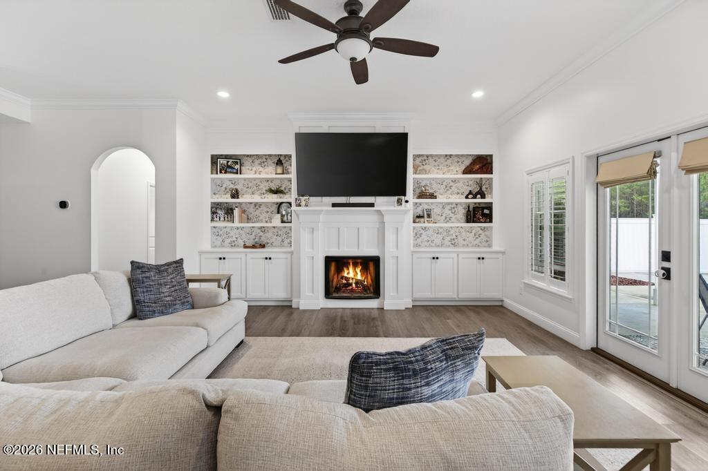 37575 Kings Ferry Road Hilliard, FL 32046 - Photo 23 of 83 a living room with furniture a flat screen tv and a fireplace