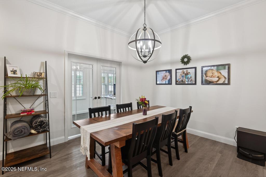 37575 Kings Ferry Road Hilliard, FL 32046 - Photo 24 of 83 a view of a dining room with furniture a chandelier and wooden floor