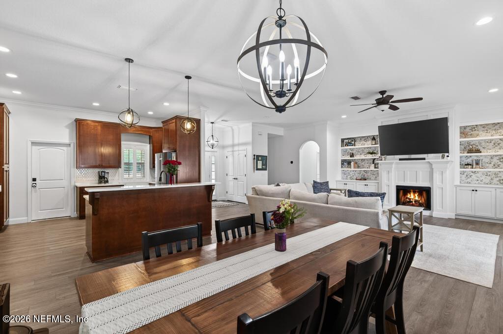 37575 Kings Ferry Road Hilliard, FL 32046 - Photo 26 of 83 a view of a dining room with furniture a chandelier and wooden floor