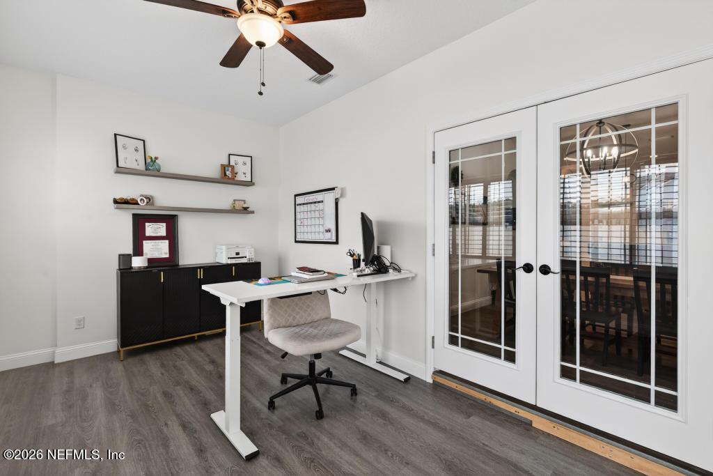 37575 Kings Ferry Road Hilliard, FL 32046 - Photo 29 of 83 a workspace with furniture wooden floor and a chandelier