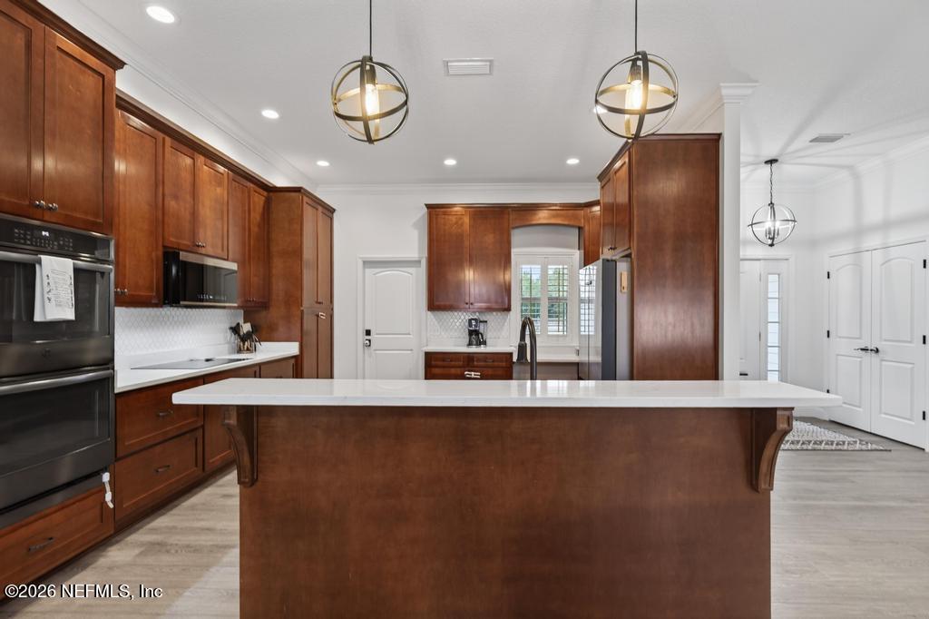 37575 Kings Ferry Road Hilliard, FL 32046 - Photo 32 of 83 a view of a kitchen with stainless steel appliances granite countertop a sink refrigerator stove and microwave