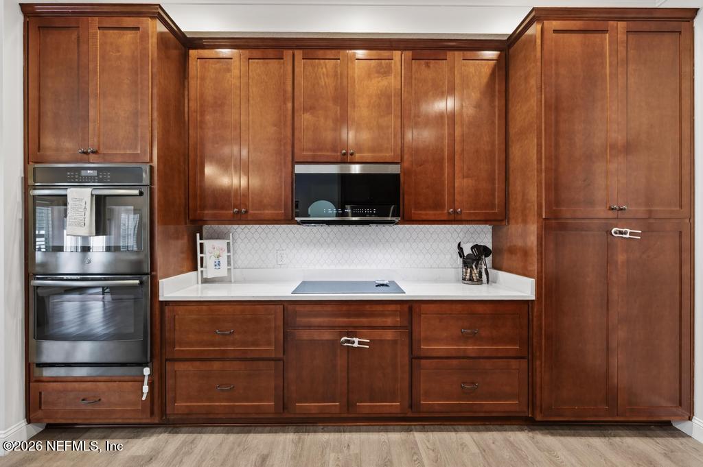 37575 Kings Ferry Road Hilliard, FL 32046 - Photo 36 of 83 a kitchen with a refrigerator and cabinets