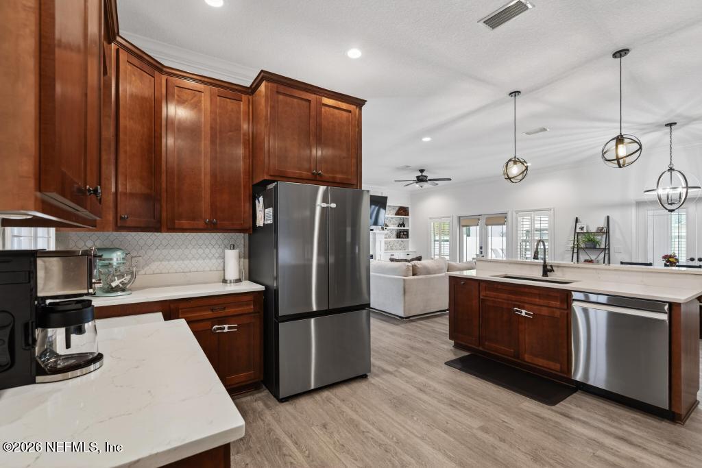 37575 Kings Ferry Road Hilliard, FL 32046 - Photo 38 of 83 a kitchen with stainless steel appliances granite countertop a refrigerator a sink dishwasher a stove and a microwave oven on granite countertops