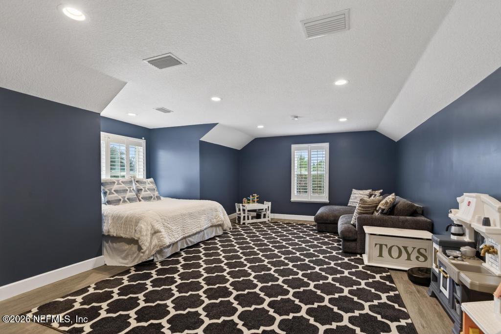 37575 Kings Ferry Road Hilliard, FL 32046 - Photo 48 of 83 a bedroom with a bed and wooden floor