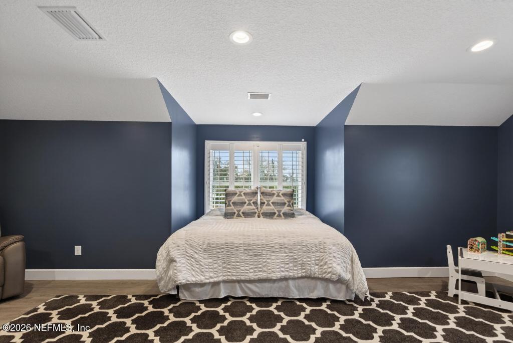 37575 Kings Ferry Road Hilliard, FL 32046 - Photo 50 of 83 a bedroom with a bed and wooden floor