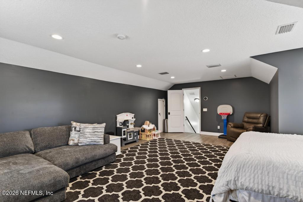 37575 Kings Ferry Road Hilliard, FL 32046 - Photo 51 of 83 a living room with furniture a flat screen tv and a lamp