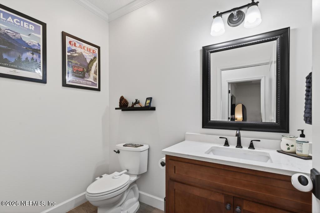 37575 Kings Ferry Road Hilliard, FL 32046 - Photo 54 of 83 a bathroom with a toilet a sink and mirror