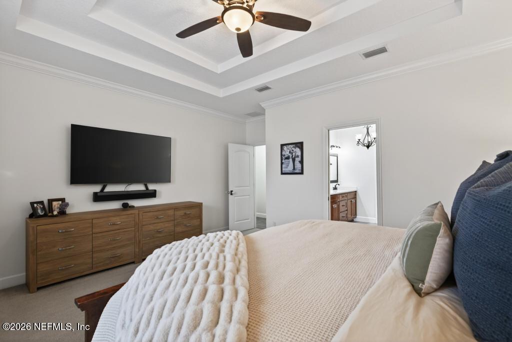 37575 Kings Ferry Road Hilliard, FL 32046 - Photo 58 of 83 a bedroom with a bed and a flat tv screen on dresser