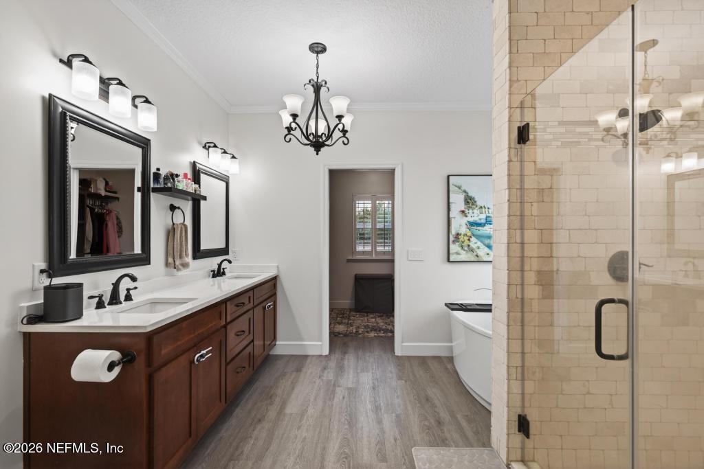37575 Kings Ferry Road Hilliard, FL 32046 - Photo 60 of 83 a spacious bathroom with a double vanity sink a mirror a bathtub and a shower