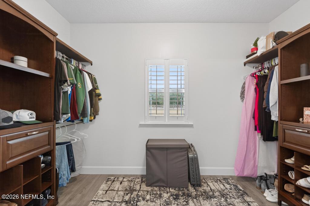 37575 Kings Ferry Road Hilliard, FL 32046 - Photo 64 of 83 a view of walk in closet with clothes and shoes