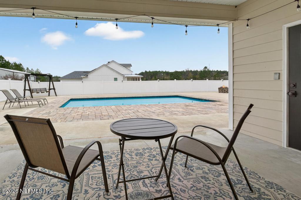 37575 Kings Ferry Road Hilliard, FL 32046 - Photo 65 of 83 a view of a table and chairs in the patio