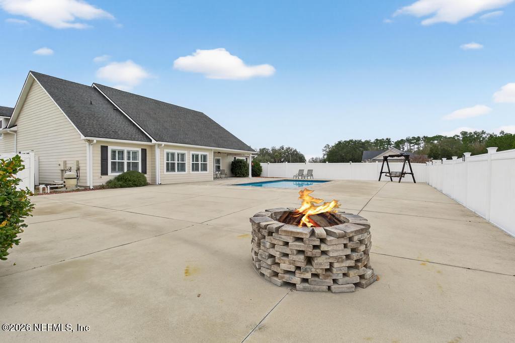 37575 Kings Ferry Road Hilliard, FL 32046 - Photo 71 of 83 a roof deck with table and chairs and potted plants