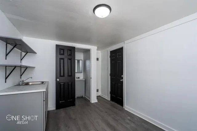 a view of a storage & utility room with closet wooden floor