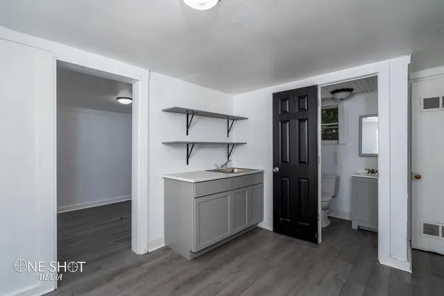a kitchen with stainless steel appliances granite countertop a sink and a refrigerator