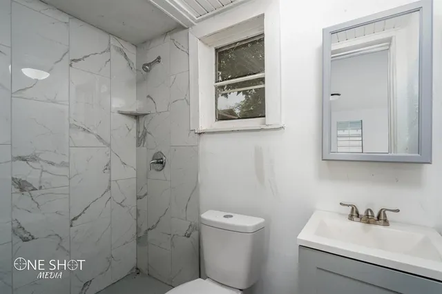 a bathroom with a toilet sink and shower