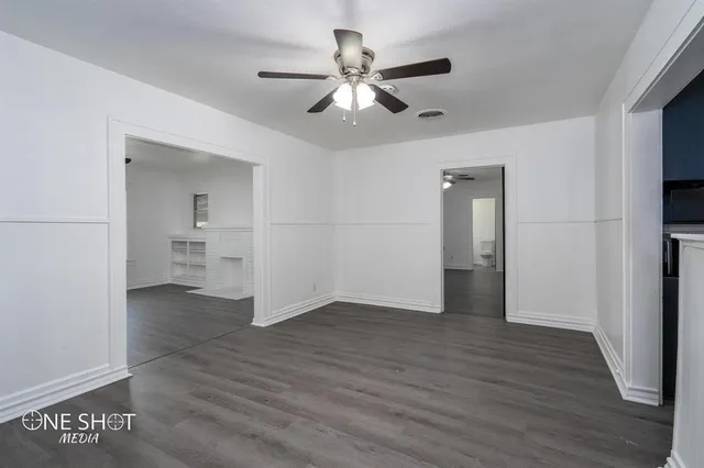 a view of an empty room and wooden floor
