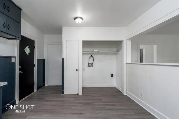 a view of empty room with wooden floor
