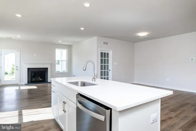 a kitchen with a stove a sink and a refrigerator