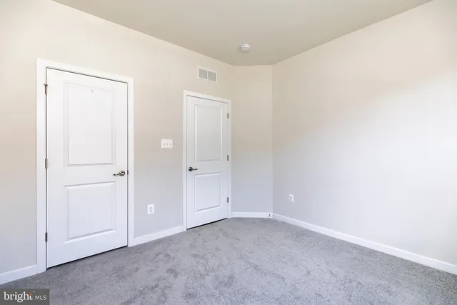 an empty room with closet area