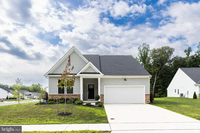 a view of house with outdoor space and garden