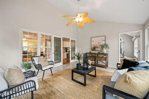 a living room with furniture and a floor to ceiling window
