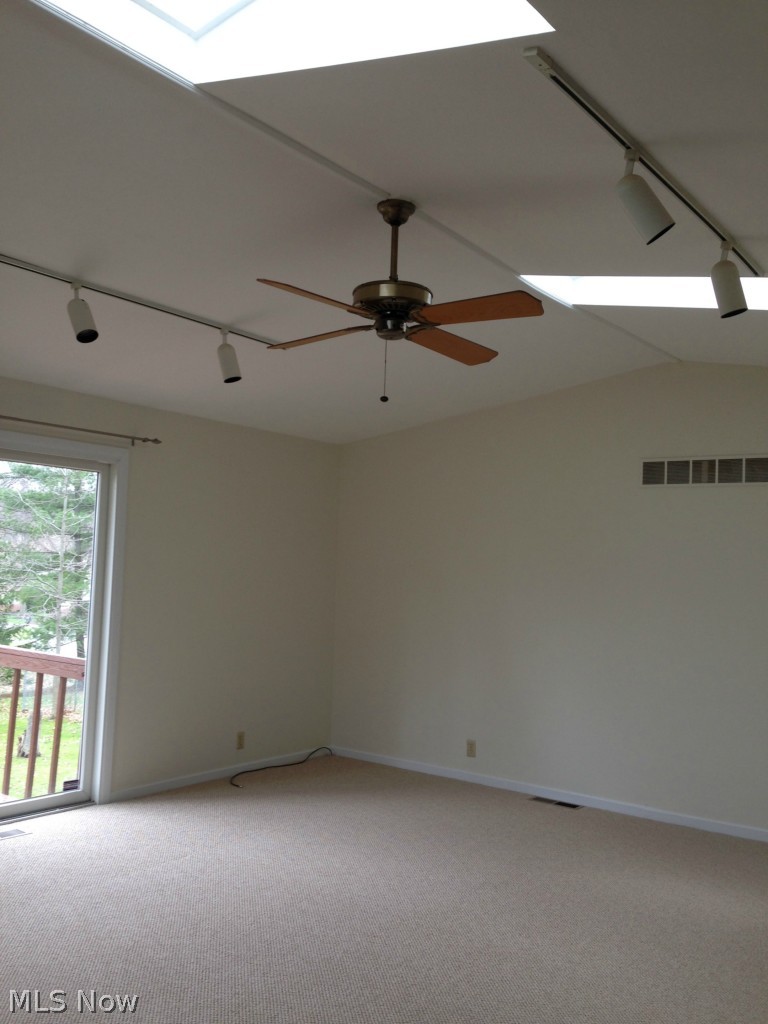 116 Callahan Road Canfield, OH 44406 - Photo 4 of 9 Great Room with Vaulted Ceilings and Skylights leads to multi level deck for entertaining.