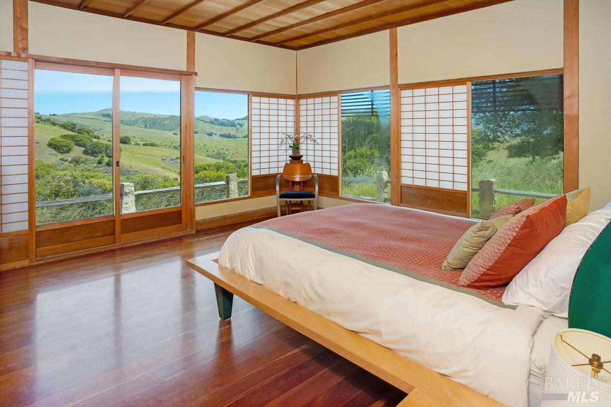 333-345 Willow Road Nicasio, CA 94946 - Photo 21 of 44 a bed sitting in a bedroom next to a large window