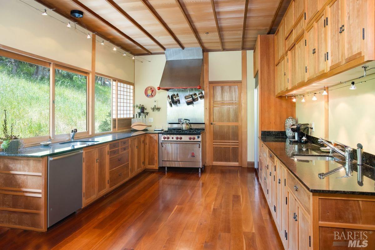 333-345 Willow Road Nicasio, CA 94946 - Photo 22 of 44 a kitchen with stainless steel appliances granite countertop a sink a stove top oven a counter space and cabinets