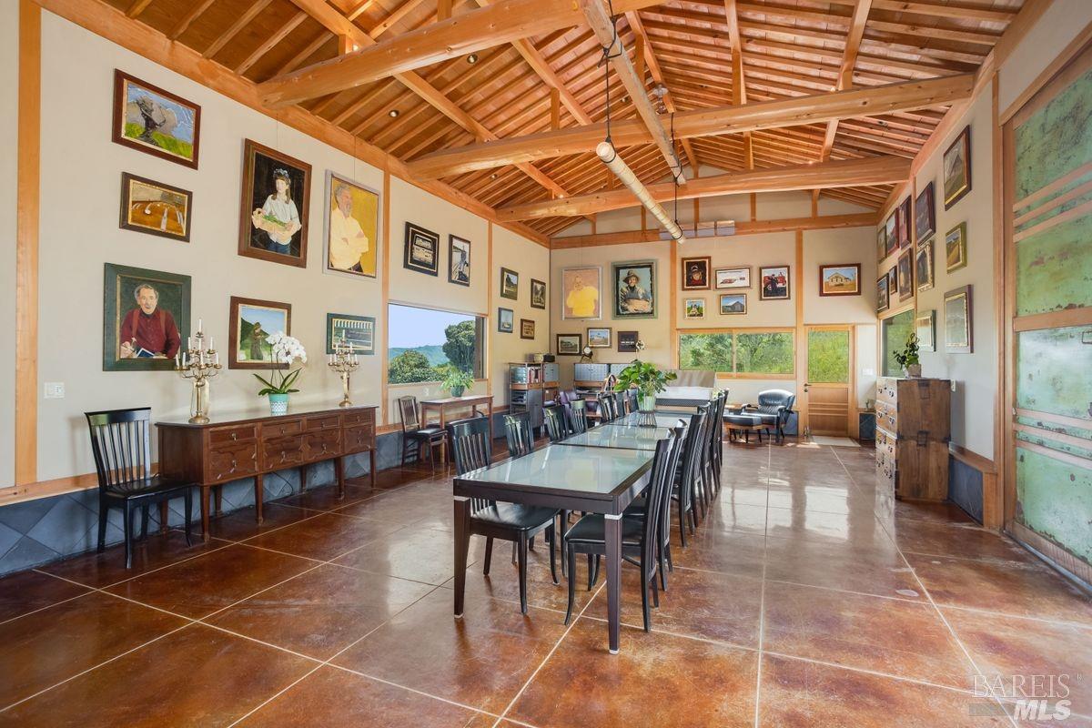 333-345 Willow Road Nicasio, CA 94946 - Photo 25 of 44 a view of a patio with dining table and chairs with wooden floor and plants