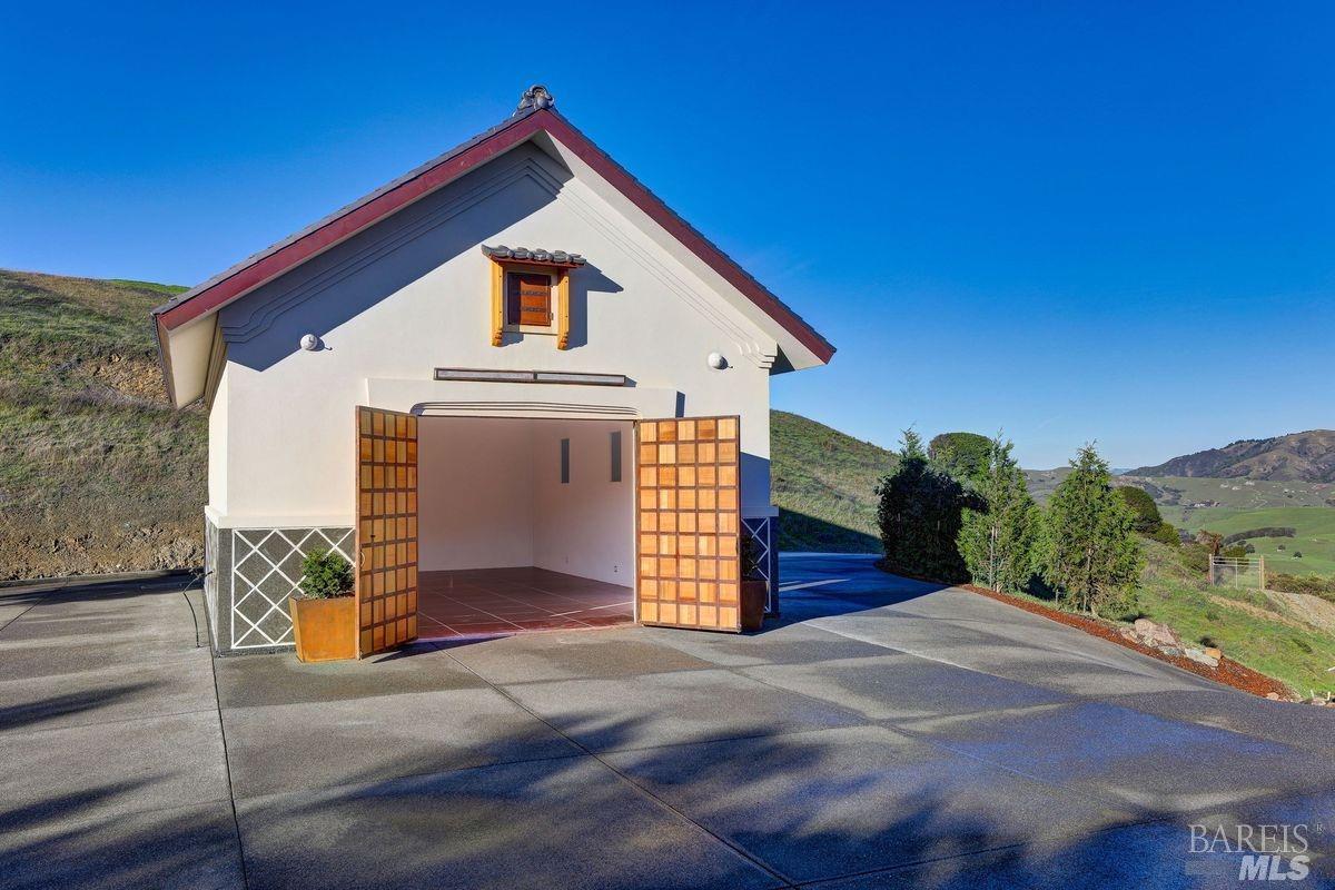 333-345 Willow Road Nicasio, CA 94946 - Photo 37 of 44 a front view of a house with a yard and garage