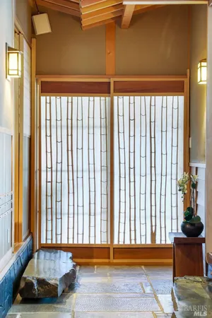 a view of a room with a window and chair